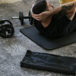 a man is doing exercises on a mat with a barbell