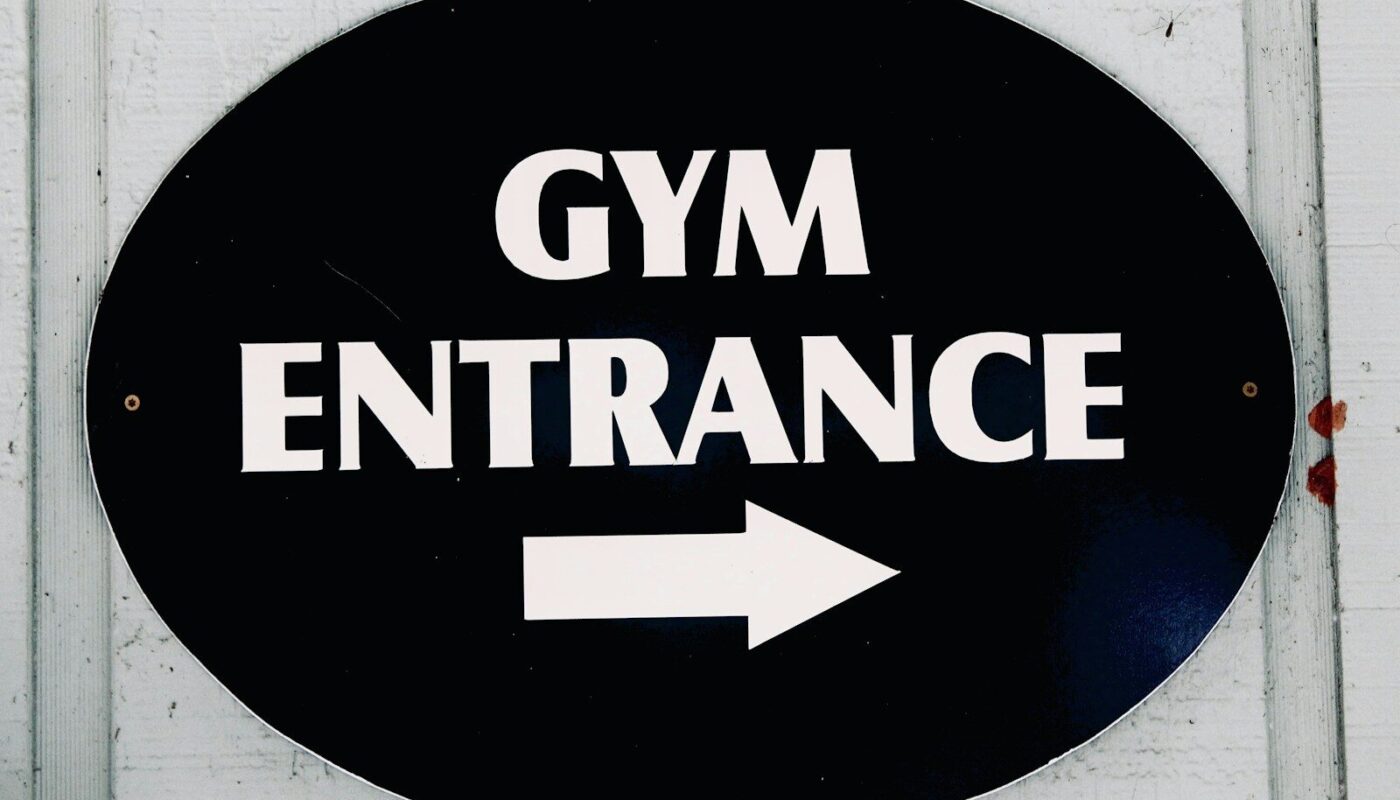 The sign points to the gym entrance.