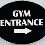The sign points to the gym entrance.