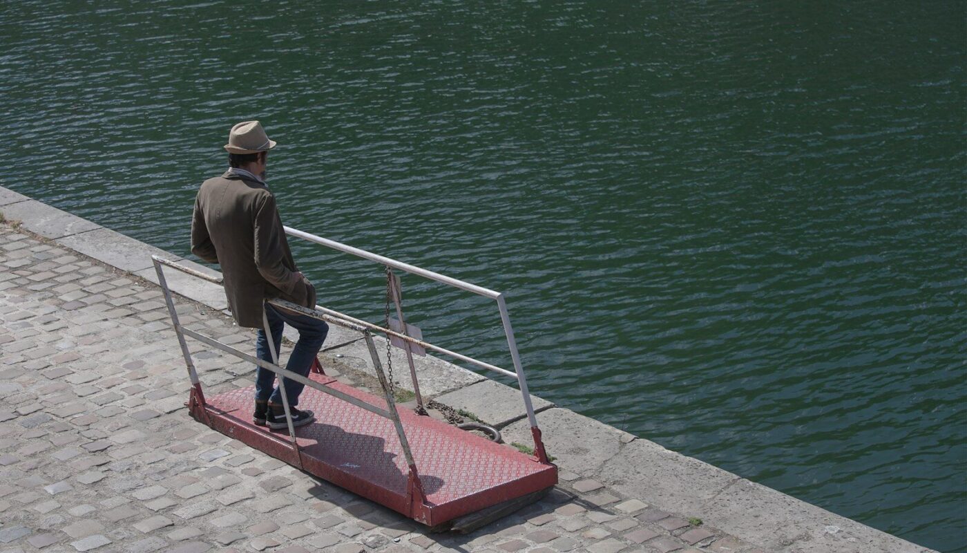 man leaning on railings