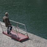 man leaning on railings