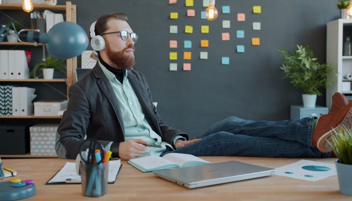 Man with headphones relaxing at his desk