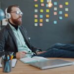 Man with headphones relaxing at his desk