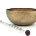 stainless steel spoon beside brown ceramic bowl