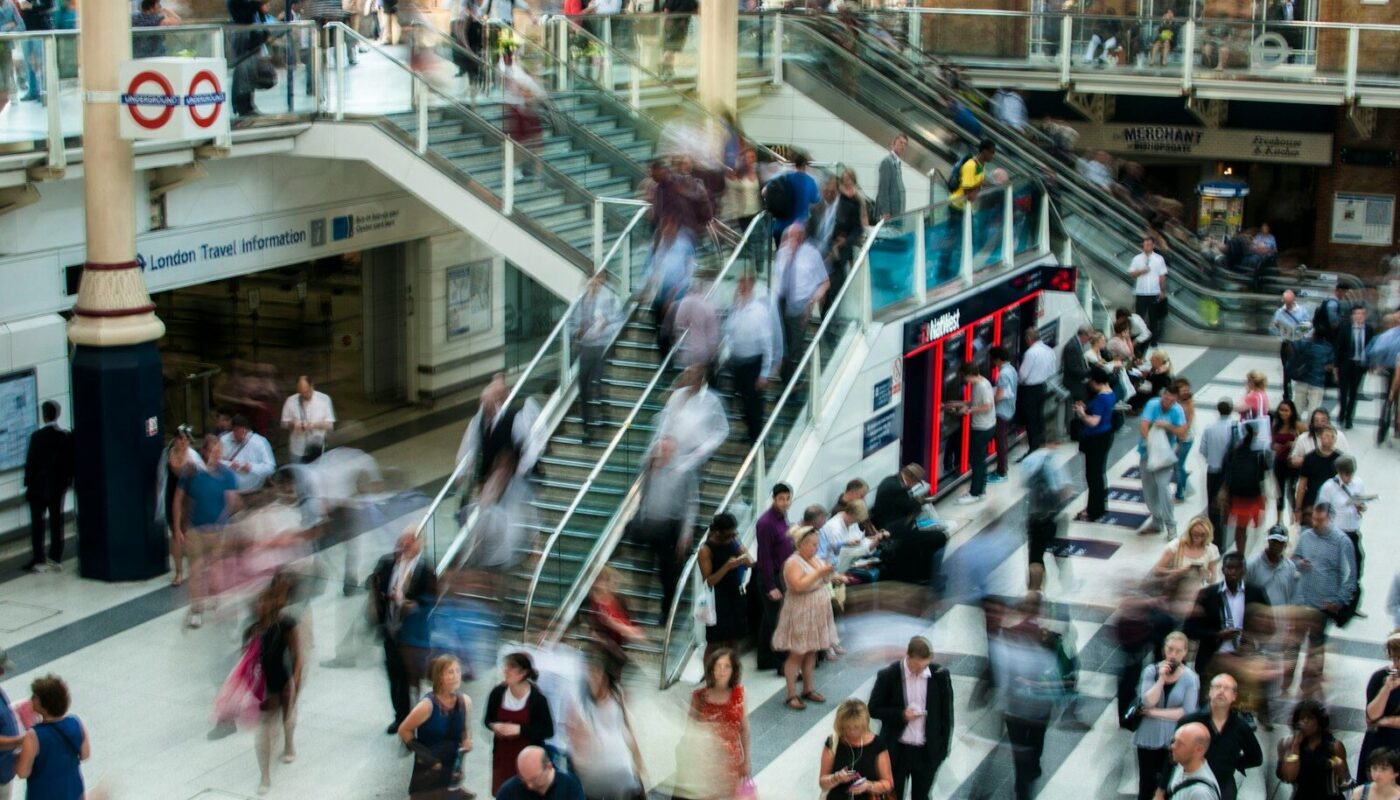 people standing and walking on stairs in mall